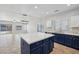 Open concept kitchen with island, stainless steel appliances, and view into Gathering room at 687 E Cleveland Ct, San Tan Valley, AZ 85140