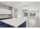 Open concept kitchen with island, looking into Gathering room and backyard at 687 E Cleveland Ct, San Tan Valley, AZ 85140