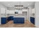 Modern kitchen with blue and white cabinets and a large island at 687 E Cleveland Ct, San Tan Valley, AZ 85140