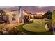 Putting green, fire pit, and pergola with patio furniture at 7860 W Taro Ln, Glendale, AZ 85308