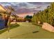 Putting green and fire pit in backyard oasis at 7860 W Taro Ln, Glendale, AZ 85308