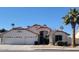 Two-story home with three car garage and desert landscaping at 7860 W Taro Ln, Glendale, AZ 85308