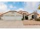 Two-story house with a three-car garage and desert landscaping at 7860 W Taro Ln, Glendale, AZ 85308