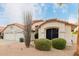 Front view of the house with two-car garage and landscaping at 7860 W Taro Ln, Glendale, AZ 85308