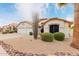 Spanish style home with two car garage and desert landscaping at 7860 W Taro Ln, Glendale, AZ 85308