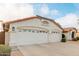 View of the two-car garage and front of the house at 7860 W Taro Ln, Glendale, AZ 85308