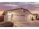 Two-car garage with desert landscaping at 7860 W Taro Ln, Glendale, AZ 85308