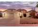 Two-story house with a two-car garage and desert landscaping at 7860 W Taro Ln, Glendale, AZ 85308