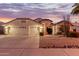 Two-story house with a two-car garage and desert landscaping at 7860 W Taro Ln, Glendale, AZ 85308