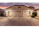 Two-car garage with desert landscaping at 7860 W Taro Ln, Glendale, AZ 85308