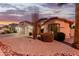 House exterior with two-car garage and desert landscaping at 7860 W Taro Ln, Glendale, AZ 85308