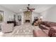 Cozy Gathering room with a stone fireplace and leather sofas at 7860 W Taro Ln, Glendale, AZ 85308