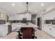 Modern kitchen with white cabinets, large island and breakfast bar at 7860 W Taro Ln, Glendale, AZ 85308