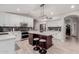 Modern kitchen with white cabinets, large island and breakfast bar at 7860 W Taro Ln, Glendale, AZ 85308