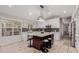 Modern kitchen with white cabinets, large island and breakfast bar at 7860 W Taro Ln, Glendale, AZ 85308