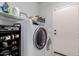 Bright laundry room with washer, dryer, and storage shelves at 7860 W Taro Ln, Glendale, AZ 85308