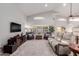 Bright and airy living room with a large TV and comfortable seating at 7860 W Taro Ln, Glendale, AZ 85308