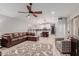 Open living room with modern kitchen and a comfy sectional sofa at 7860 W Taro Ln, Glendale, AZ 85308