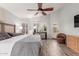 Main bedroom features a king-size bed, ceiling fan, and access to backyard at 7860 W Taro Ln, Glendale, AZ 85308