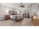 Spacious main bedroom with wood flooring, large windows, and ceiling fan at 7860 W Taro Ln, Glendale, AZ 85308