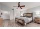 Bright main bedroom with wood flooring, a ceiling fan and lots of natural light at 7860 W Taro Ln, Glendale, AZ 85308