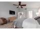 Main bedroom with wood flooring, large windows, and ensuite bathroom access at 7860 W Taro Ln, Glendale, AZ 85308