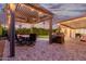 Covered patio with dining table, grill, and string lights at 7860 W Taro Ln, Glendale, AZ 85308