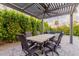 Pergola-covered patio with dining table at 7860 W Taro Ln, Glendale, AZ 85308