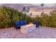 Outdoor seating area with fire pit and lush greenery at 7860 W Taro Ln, Glendale, AZ 85308