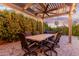 Relaxing patio area with dining table and ceiling fan at 7860 W Taro Ln, Glendale, AZ 85308