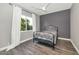 Cozy bedroom with wood-look floors, large window, and ceiling fan at 8712 W Sequoia Dr, Peoria, AZ 85382