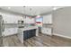 Modern kitchen with white cabinets, large island, and stainless steel appliances at 8712 W Sequoia Dr, Peoria, AZ 85382