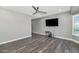 Living room with wood-look floors and mounted TV at 8712 W Sequoia Dr, Peoria, AZ 85382