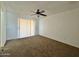 Bright bedroom with carpet flooring and sliding door at 8738 W Tinajas Dr, Arizona City, AZ 85123