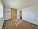 Bedroom with mirrored closet doors and carpet at 8738 W Tinajas Dr, Arizona City, AZ 85123