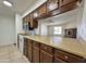 View of kitchen with pass-through to living room and breakfast bar at 8738 W Tinajas Dr, Arizona City, AZ 85123