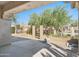 Private backyard with a paved patio, mature trees, and access to a community pool at 8965 E Maple Dr, Scottsdale, AZ 85255