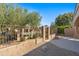 Landscaped backyard with a gate leading to a community pool at 8965 E Maple Dr, Scottsdale, AZ 85255