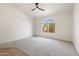 Bright bedroom with neutral wall paint, ceiling fan, and grey carpeting at 8965 E Maple Dr, Scottsdale, AZ 85255