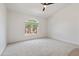 Bright bedroom with neutral carpeting and an arched window at 8965 E Maple Dr, Scottsdale, AZ 85255