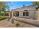 Rear exterior view of the home showcasing a gated patio and yard at 8965 E Maple Dr, Scottsdale, AZ 85255