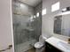 Modern bathroom featuring tiled shower with glass door, gold fixtures, and updated vanity at 9672 E Davenport Dr, Scottsdale, AZ 85260