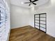 Bedroom featuring hardwood floors, a window with shutters and a large, modern closet at 9672 E Davenport Dr, Scottsdale, AZ 85260