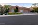 Charming single-story home featuring a neutral color, tile roof, manicured lawn, and two-car garage at 9672 E Davenport Dr, Scottsdale, AZ 85260