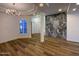 Modern living room featuring elegant lighting, marble accent wall, hardwood floors, and shutters at 9672 E Davenport Dr, Scottsdale, AZ 85260