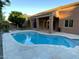 Inviting pool in a backyard featuring a covered patio and lush landscaping at 9672 E Davenport Dr, Scottsdale, AZ 85260