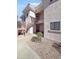 Exterior view of condo building with stairs and landscaping at 10030 W Indian School Rd # 101, Phoenix, AZ 85037