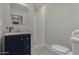 Bathroom with navy vanity and walk-in shower at 1022 E Mariposa St, Phoenix, AZ 85014