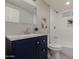 Modern bathroom with navy vanity and shower/tub combo at 1022 E Mariposa St, Phoenix, AZ 85014