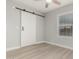 Bedroom with barn door and ceiling fan at 1022 E Mariposa St, Phoenix, AZ 85014